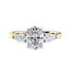 Oval natural diamond 3 stone engagement ring with pear shaped side stones 18ct gold front view.