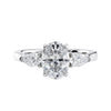 Oval natural diamond 3 stone engagement ring with pear shaped side stones white gold front view.