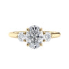 Oval diamond 3 stone engagement ring with small side diamonds 18ct gold front view.