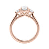 Oval diamond 3 stone engagement ring with small side diamonds rose gold side view.