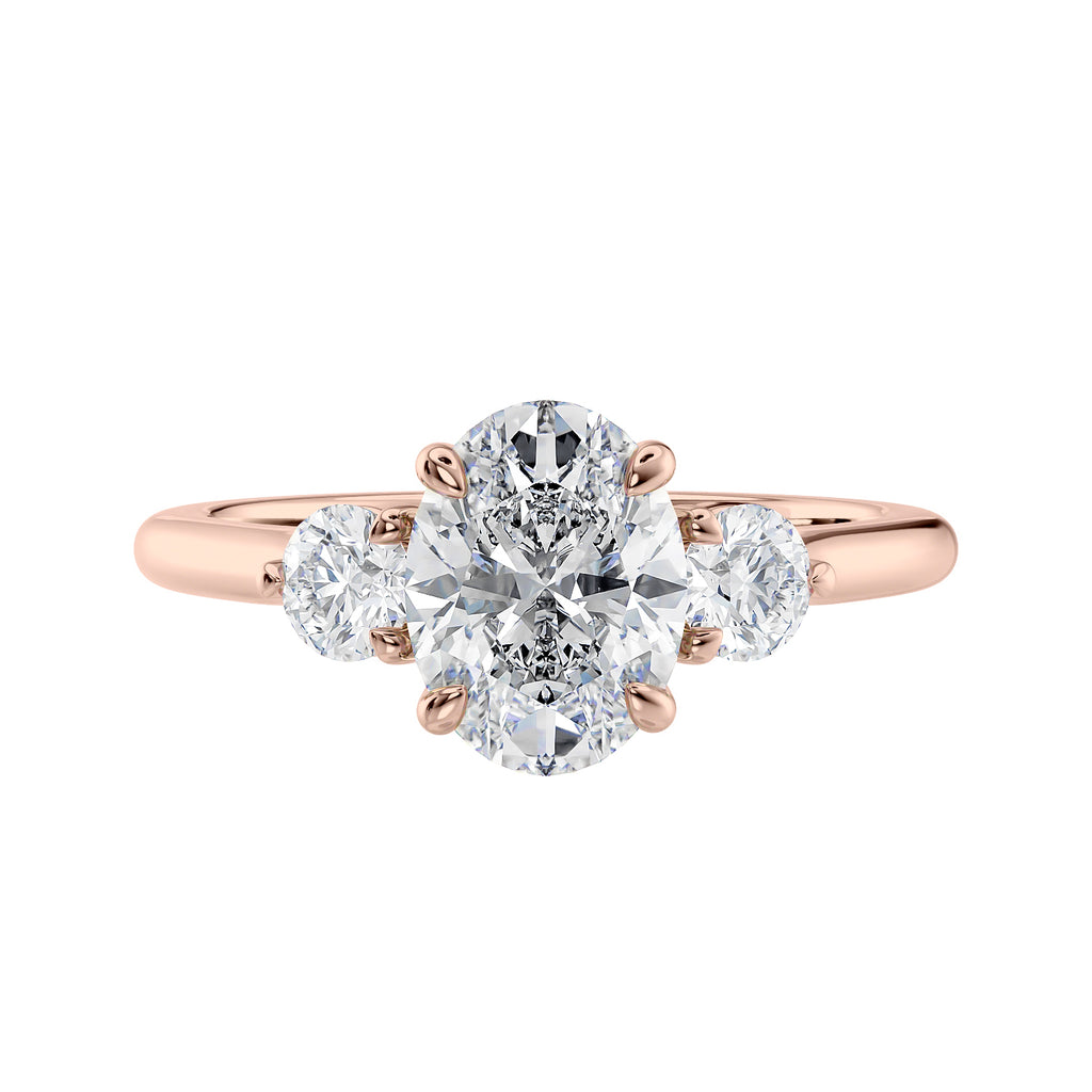 Oval diamond 3 stone engagement ring with small side diamonds rose gold front view.