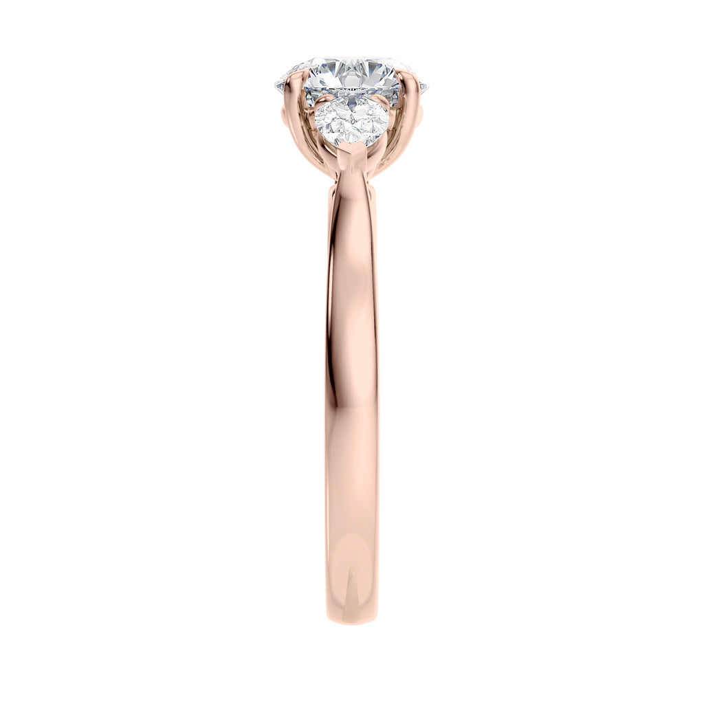 Lab grown diamond trilogy style engagement ring with pear sides rose gold end view.