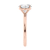 Round brilliant solitaire natural diamond engagement ring with a rose gold band end view.