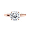 Round brilliant solitaire natural diamond engagement ring with a rose gold band front view.