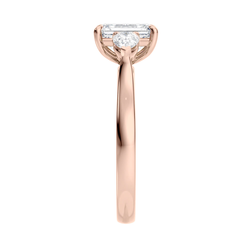 1 carat emerald cut with pear cut sides diamond engagement ring 18 rose gold end view.