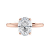 Oval cut diamond engagement ring in contemporary style setting 18 carat rose gold front view.