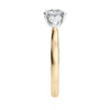 Round 3 stone natural diamond engagement ring with pear shoulders in gold end view.