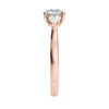 Round 3 stone natural diamond engagement ring with pear shoulders in rose gold end view.