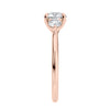 Round brilliant cut diamond 3 stone engagement ring with small side diamonds rose gold end view.