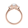 Round brilliant cut diamond 3 stone engagement ring with small side diamonds rose gold side view.