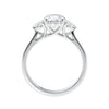 Round brilliant cut diamond 3 stone engagement ring with small side diamonds white gold side view.