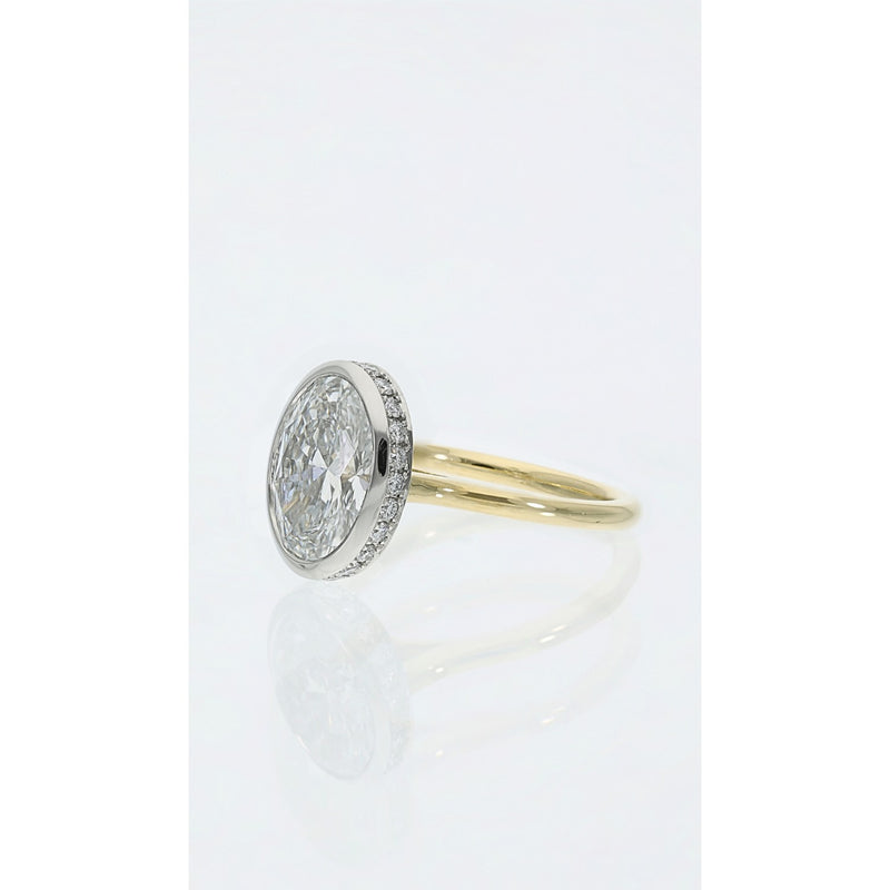 oval bezel set diamond ring in yellow gold with hidden halo detail side view