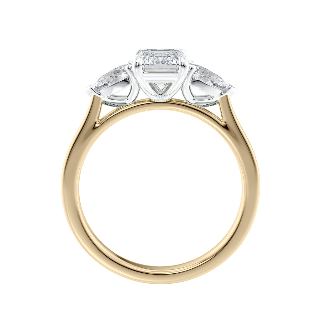 Emerald cut diamond engagement ring with pear cut sides 18ct gold side view.