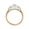 Emerald cut diamond engagement ring with pear cut sides 18ct gold side view.