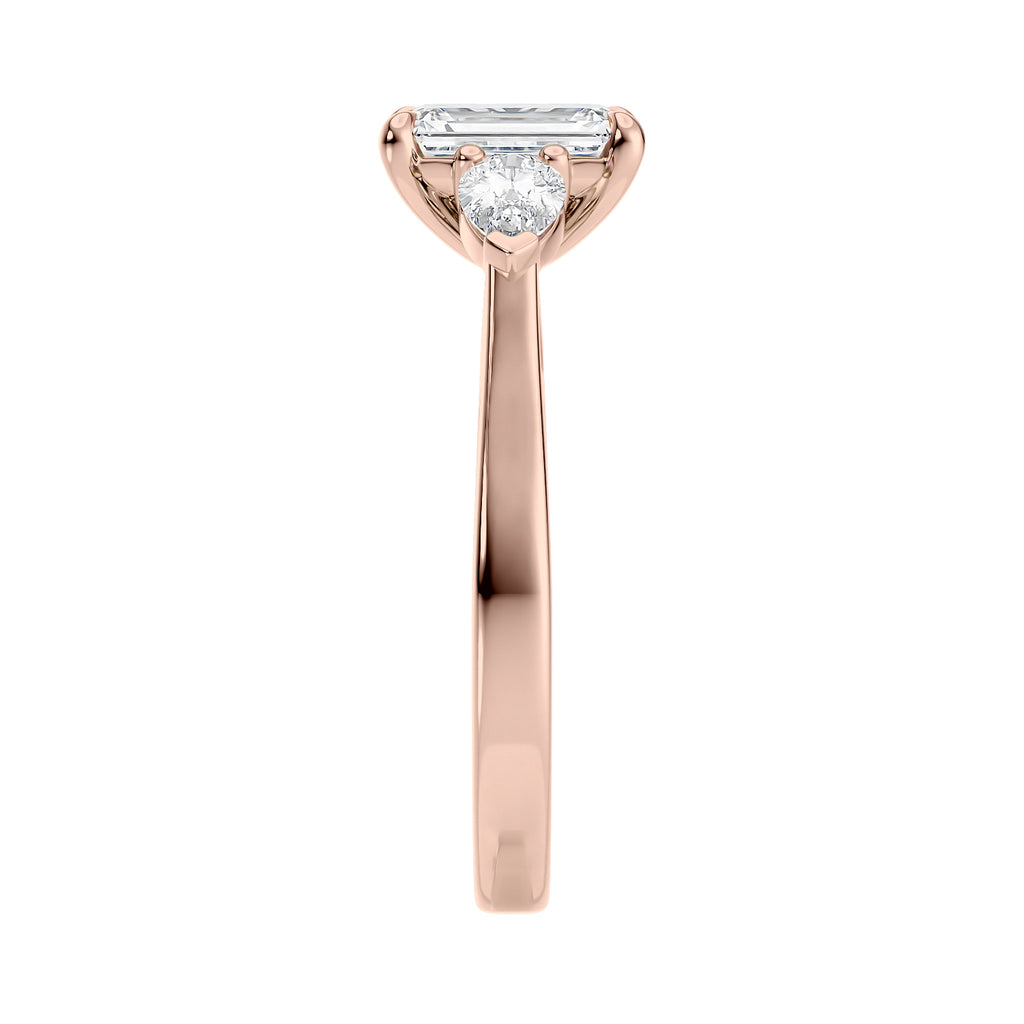 Emerald cut diamond engagement ring with pear cut sides 18ct rose gold end view.