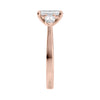 Emerald cut diamond engagement ring with pear cut sides 18ct rose gold end view.