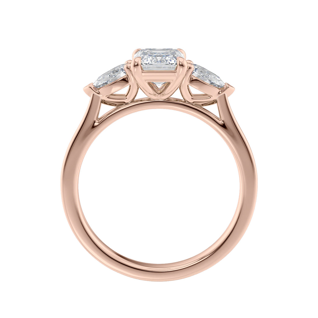 Emerald cut diamond engagement ring with pear cut sides 18ct rose gold side view.