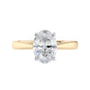 Lab grown oval cut diamond engagement ring with tapered band gold front view.