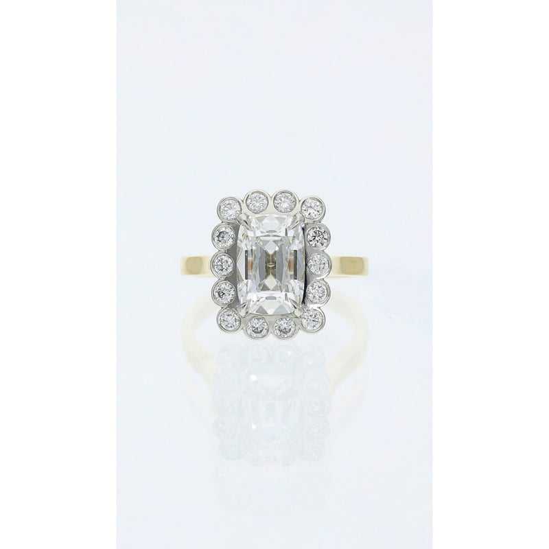 old mine cut diamond cluster ring with bezel set halo in gold and platinum