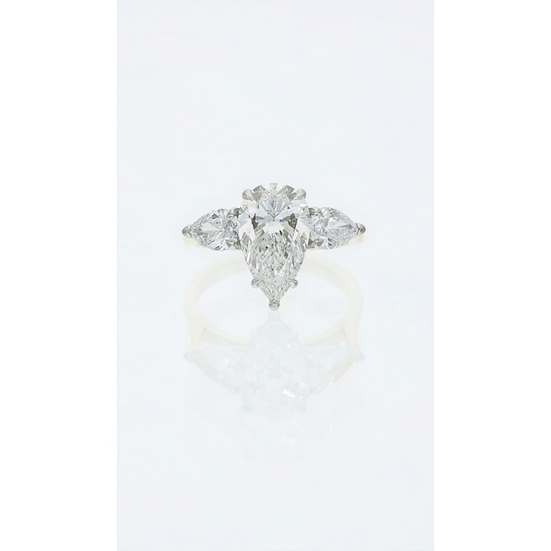 Pear cut three stone diamond ring in platinum and gold