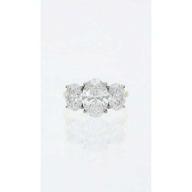 Oval three stone diamond ring in platinum and gold