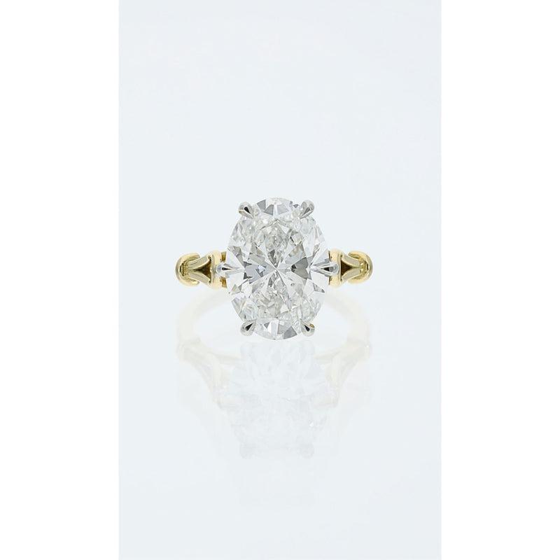 Oval cut diamond solitaire ring in platinum and gold