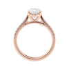 Natural oval cut engagement ring with tapered diamond rose gold band side view.