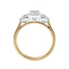 Emerald and pear cut natural diamond trilogy engagement ring 18ct gold side view.
