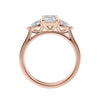 Emerald and pear cut natural diamond trilogy engagement ring 18ct rose gold side view.