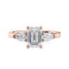 Emerald and pear cut natural diamond trilogy engagement ring 18ct rose gold front view.