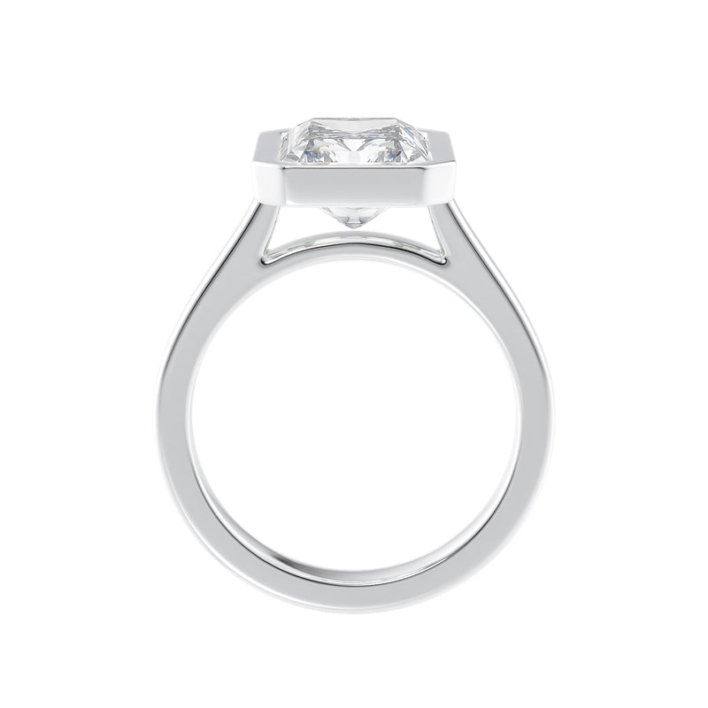 Solitaire emerald cut bezel set lab grown diamond engagement ring in white gold side view.