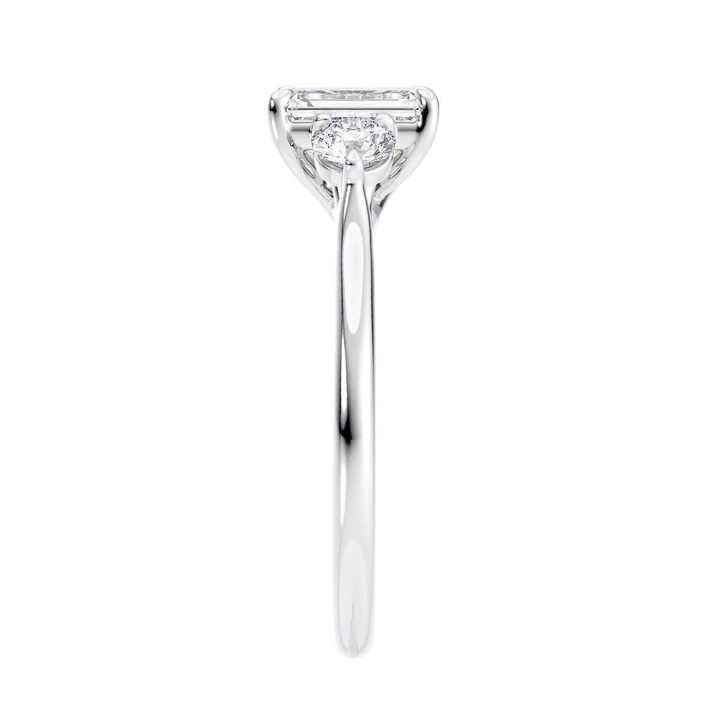 Emerald cut natural diamond 3 stone engagement ring white gold end view.