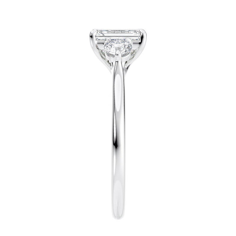 Emerald cut natural diamond 3 stone engagement ring white gold end view.