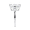 Emerald cut natural diamond engagement ring with tapered baguette shoulders white gold end view.