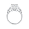 Emerald cut natural diamond engagement ring with tapered baguette shoulders white gold side view.