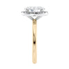 Oval halo diamond engagement ring in gold end view.