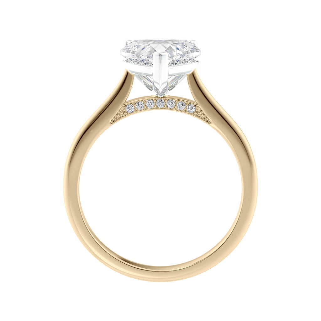 Laboratory grown heart cut diamond solitaire engagement ring with diamond set bridge 18ct gold side view.