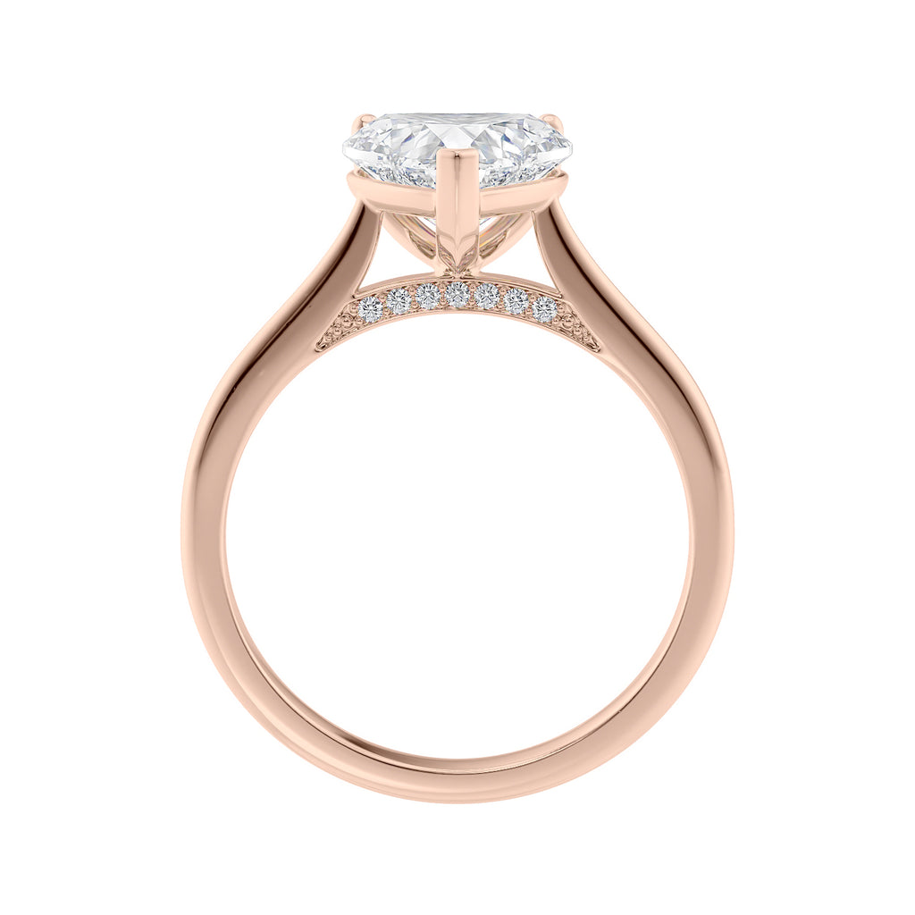 Laboratory grown heart cut diamond solitaire engagement ring with diamond set bridge 18ct rose gold side view.
