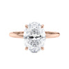 Hidden halo oval lab grown diamond engagement ring slim band rose gold front view.