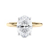 Hidden halo oval lab grown diamond engagement ring slim band gold front view.