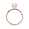 Hidden halo oval lab grown diamond engagement ring slim band rose gold side view.
