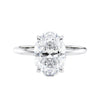 Hidden halo oval lab grown diamond engagement ring slim band white gold front view.