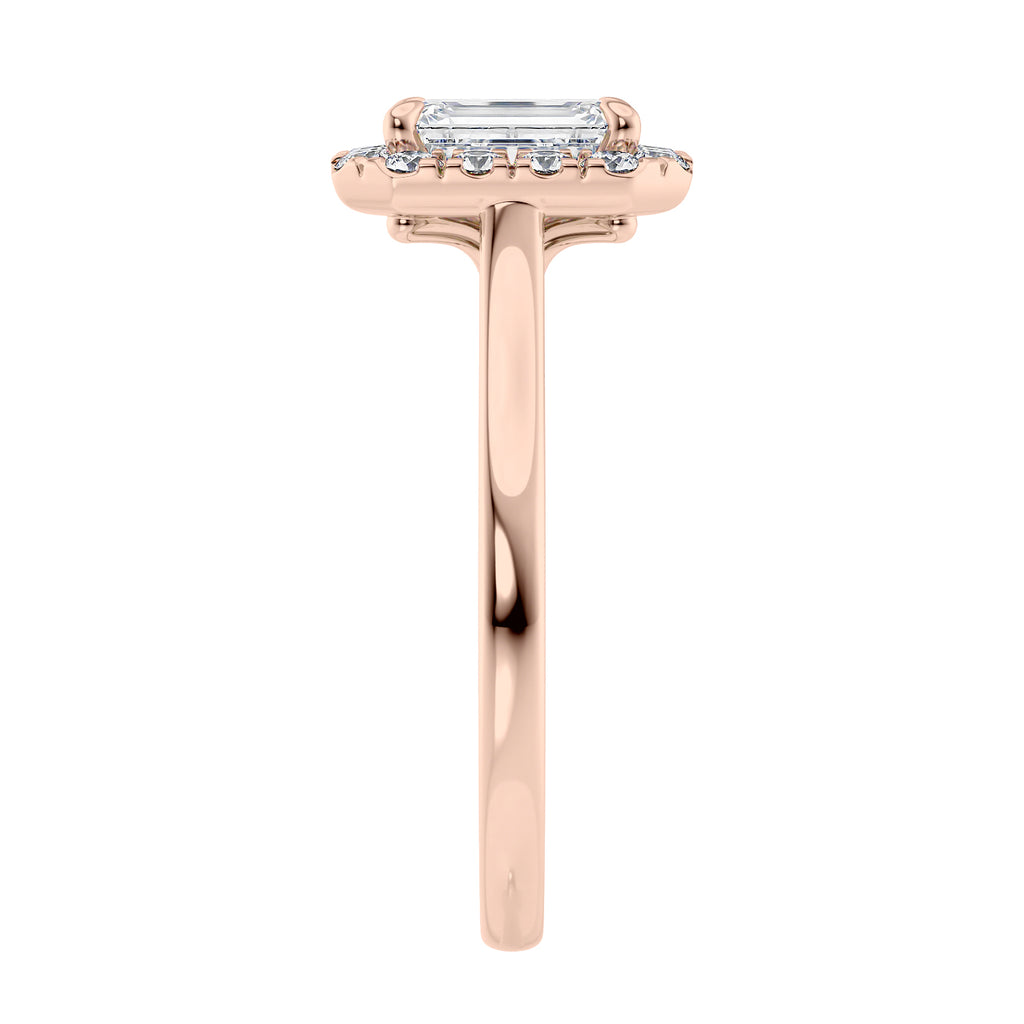 Emerald cut diamond halo style engagement ring rose gold end view.