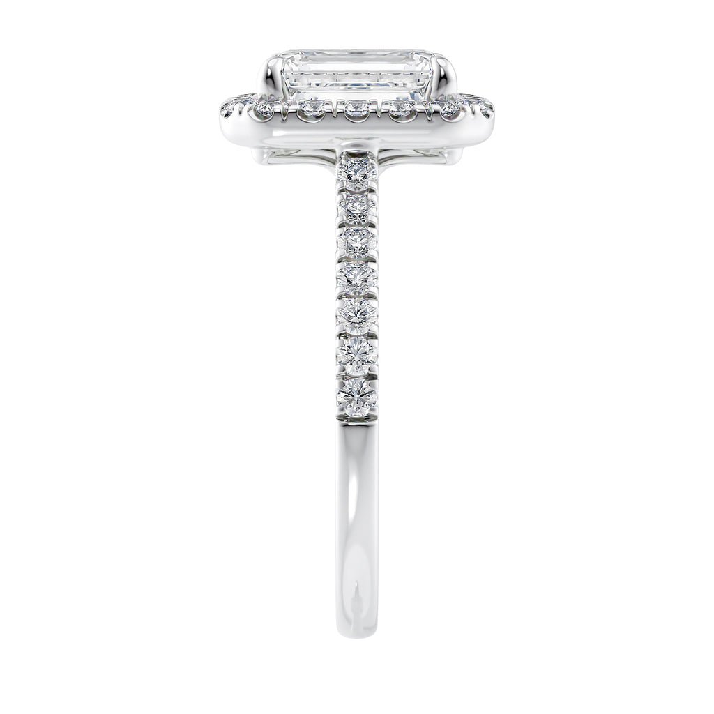 Natural diamond emerald cut halo style engagement ring white gold end view.