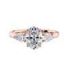 Oval 3 stone diamond engagement ring with pear side stones 18ct rose gold front view.