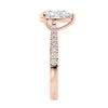 Pear solitaire engagement ring with tapered diamond set rose gold band end view.