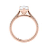 Pear solitaire engagement ring with tapered diamond set rose gold band side view.