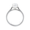 Pear solitaire engagement ring with tapered diamond set white gold band side view.