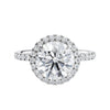 Brilliant cut diamond halo style engagement ring with diamond band white gold front view.