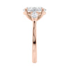 3 stone oval and pear diamond engagement ring rose gold end view.